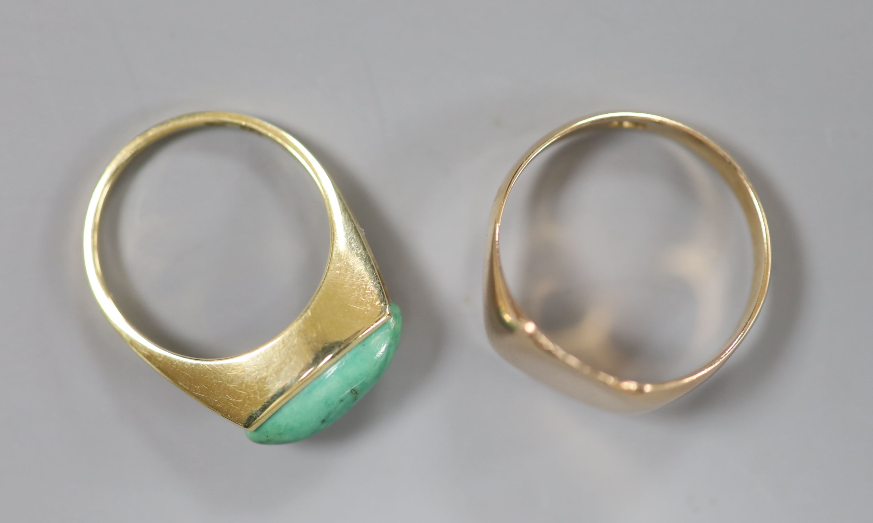 A 9ct signet ring, size T, gross 4.6 grams and a 585 yellow metal and turquoise? set ring, size O, gross 3.8 grams.